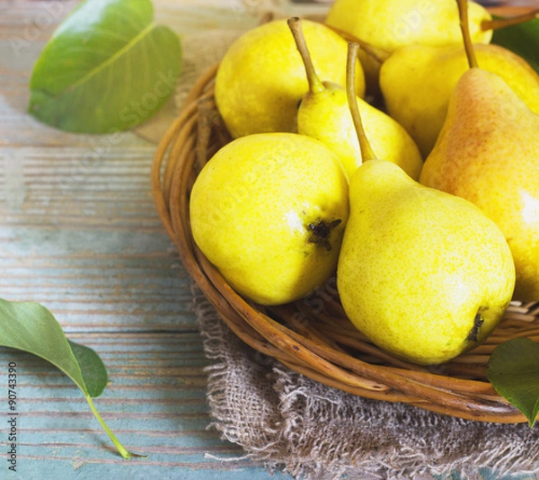 Obraz Wicker basket of ripe pears, close up