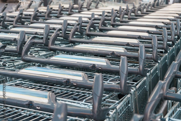 Obraz Supermarket shopping carts organized in rows