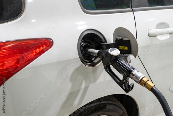 Obraz Refueling a car with diesel at a gas station