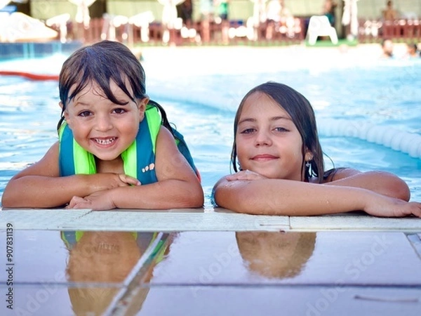 Obraz “Close-up portrait of two smiling Caucasian siblings at the pool”