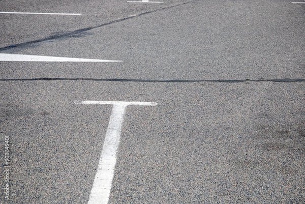 Fototapeta A close up of a road with a white line, asphalt surface, and parallel sidewalk