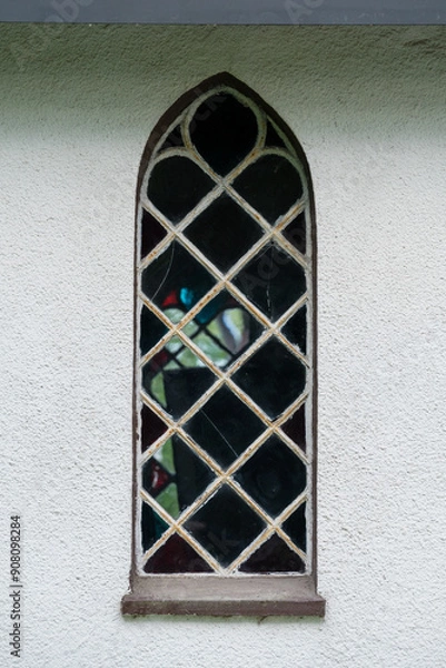 Fototapeta Small ornamental chapel window on the light wall