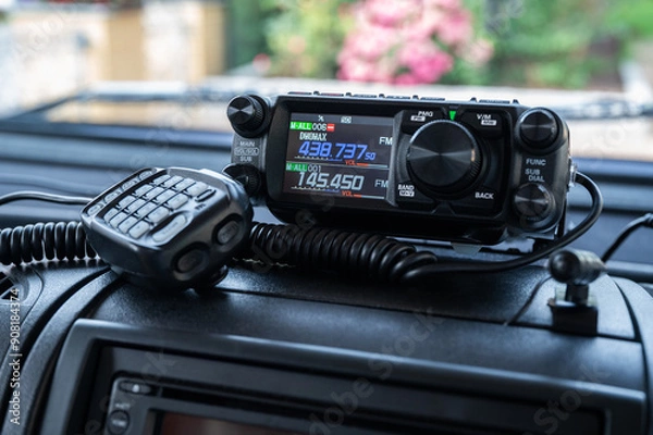 Fototapeta Mobile amateur radio transceiver with microphone for the 2m and 70cm band on a car dashboard