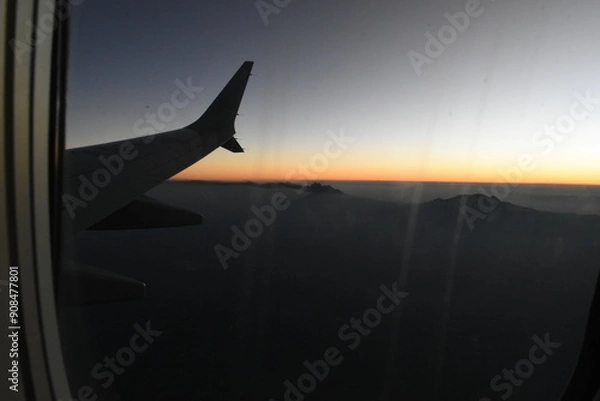Fototapeta airplane landing at sunset