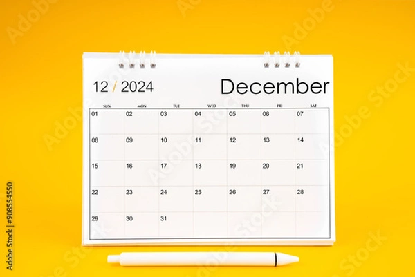 Fototapeta December 2024, Monthly desk calendar for 2024 year and pen on yellow background.