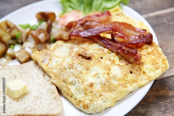 Fototapeta Breakfast with bacon , fried egg and bread