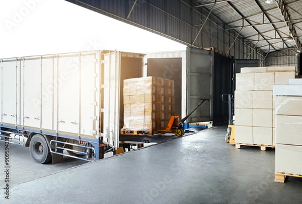 Fototapeta Bulk pallets of packaging boxes being loaded onto a container truck. distribution warehouse Container transport, supply chain, parcel delivery. Freight truck, logistics, transportation.