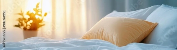 Fototapeta A cozy bedroom scene showcasing a soft pillow and a plant, illuminated by warm sunlight filtering through sheer curtains.