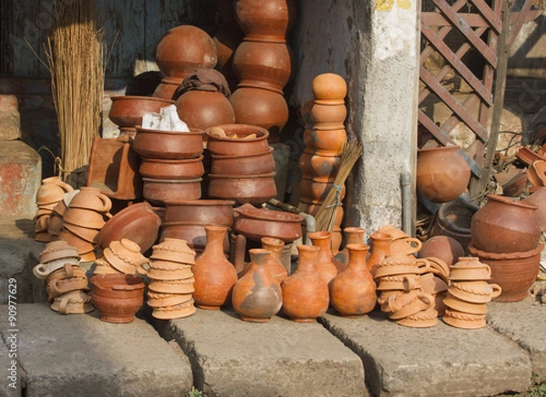 Fototapeta Pottery of different sizes exhibited in the street 