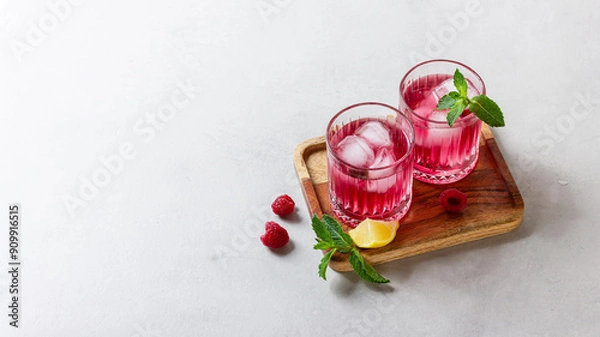 Obraz Raspberry cocktail with ice in a glass on a light background