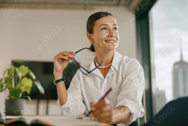 Fototapeta A Confident and Ambitious Businesswoman Engaging in Deep Reflection Within a Modern Office Space