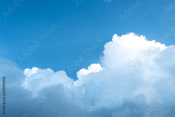 Obraz Rainy clouds transforming from white to dark and expanding on blue sky.