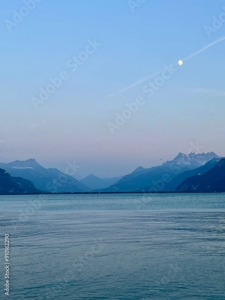 Obraz Lake Geneva and Swiss Alps landscape view at dusk with the moon in the sky.  No people. 
