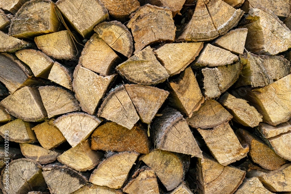 Fototapeta Firewood storage concept. Natural sawn wood stacked in row, texture. Stacks of chopped logs as background. Romantic winter in front of fireplace. Wallpaper.