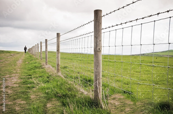 Fototapeta Man walking alone in countryside