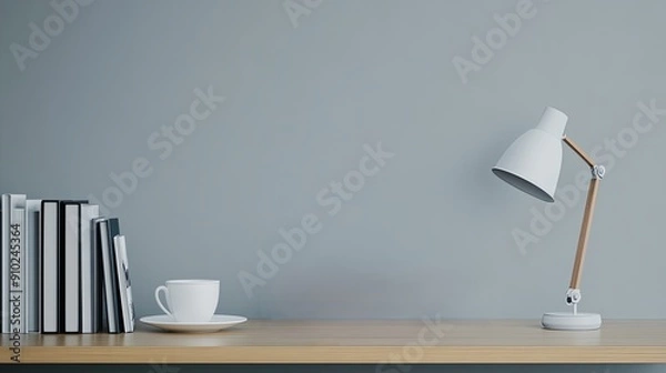Fototapeta Stack of books, a reading lamp, and a cup of coffee, copy space on bookshelf