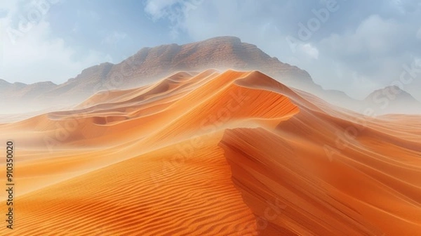 Fototapeta Sunlight illuminating rolling sand dunes in a vast desert