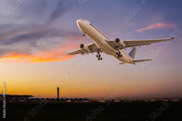Fototapeta Commercial airplane take off at sunset