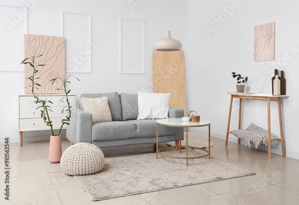 Fototapeta Comfortable sofa, coffee table and bamboo plant in interior of living room