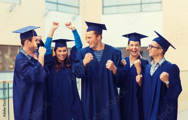Fototapeta group of smiling students in mortarboards