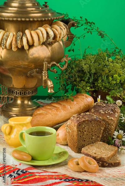Obraz Russian water boiler called "Samovar", greenery and cup of tea