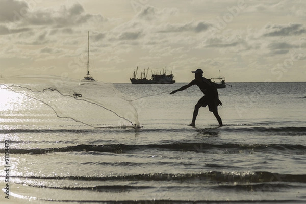 Fototapeta the fisherman he is casting fishing on the seaside