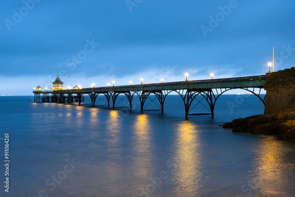 Fototapeta The Grade 1 listed 'Cleveland Pier' in the Bristol Channel illuminated at dusk