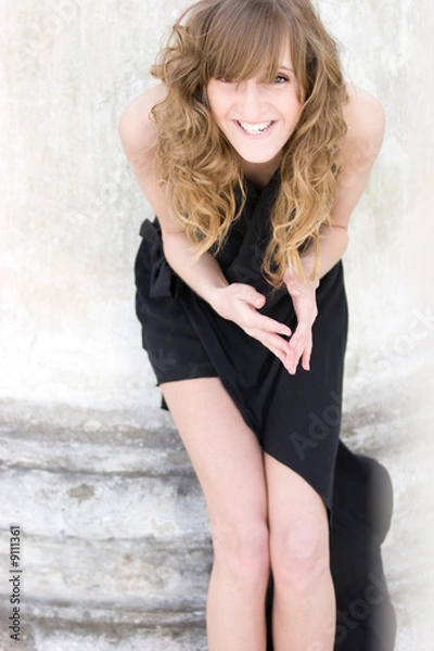 Fototapeta Young fashion model  posing in sexy black dress