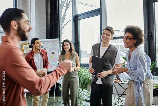 Obraz Colleagues share laughter and conversation while facing a challenging moment.