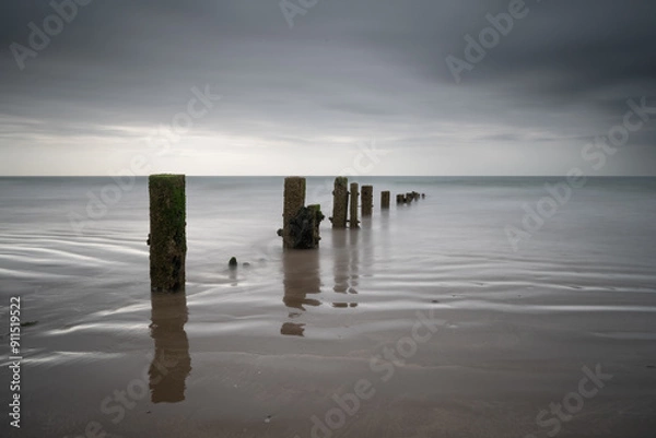 Obraz Youghal Strand Groynes on a warm summer morning just before the rain comes