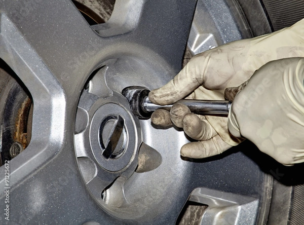 Fototapeta Mechanic Removing Lug Nut