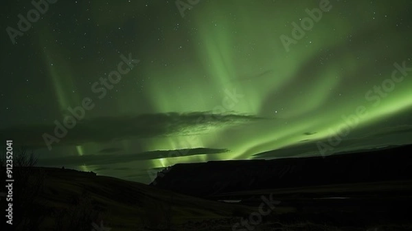 Fototapeta "Icelandic Aurora: A Majestic Display of Northern Lights over Pristine Landscapes"