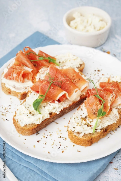Obraz Plate of tasty bruschettas with jamon on light background