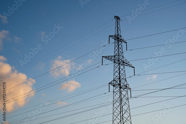 Fototapeta Power lines with wires on blue sky with clouds