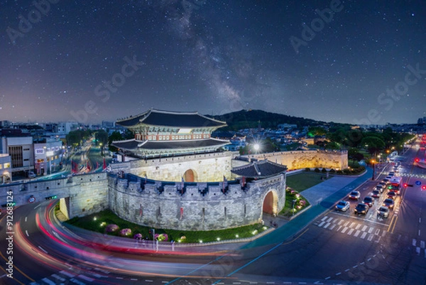 Obraz Hwaseong Fortress at night, Traditional Architecture of Korea at Suwon and the Milky Way in the background, South Korea.
