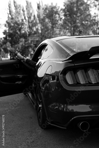 Fototapeta woman's legs with shoes by the way the supercar window on vacation. Concept of happiness and fun during the trip in the summer