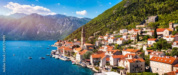 Fototapeta View of the historic town of Perast at famous Bay of Kotor on a beautiful sunny day with blue sky and clouds in summer, Montenegro. Historic city of Perast at Bay of Kotor in summer, Montenegro.
