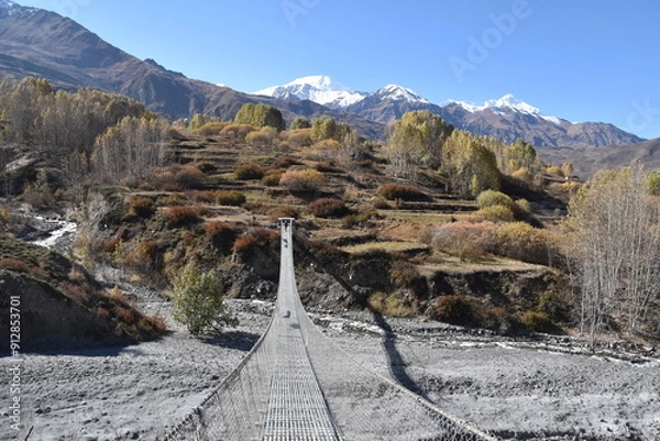 Obraz A high suspension bridge hanging over a valley in Mustang, Nepal