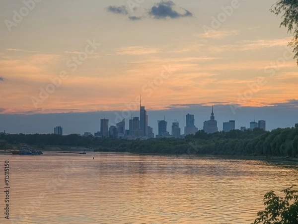 Fototapeta Warsaw skyline at the sunset from the river perspective. 