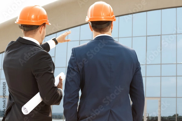Fototapeta Two architect assessing their building progress