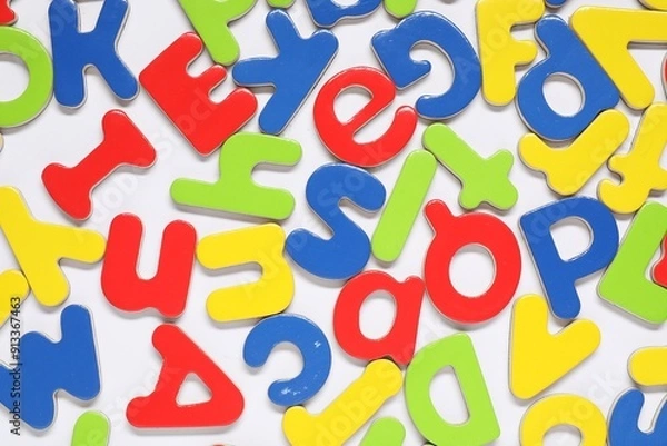 Fototapeta Alphabet. Many colorful magnetic letters on white background, flat lay