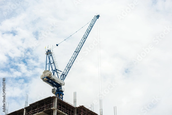Fototapeta Construction crane on tower