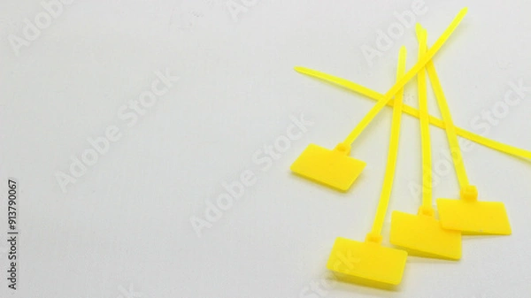 Fototapeta Yellow cable ties with markings isolated