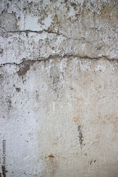 Fototapeta Vertical view of weathered concrete and stucco colonial wall in Asia. Horizontal crack crosses frame.