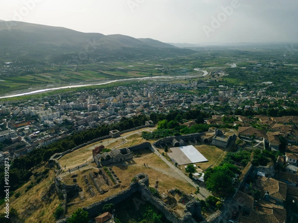 Fototapeta BERAT, ALBANIA, April 13, 2024: Berat castle viewed from boulevard Republika in Albania