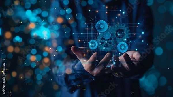 Obraz Businessman is holding virtual gears connected with lines, representing automation of business processes, optimization and new technologies