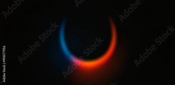 Fototapeta A vibrant abstract gradient background featuring a glowing light effect in blue, orange, and red hues against a dark backdrop.
