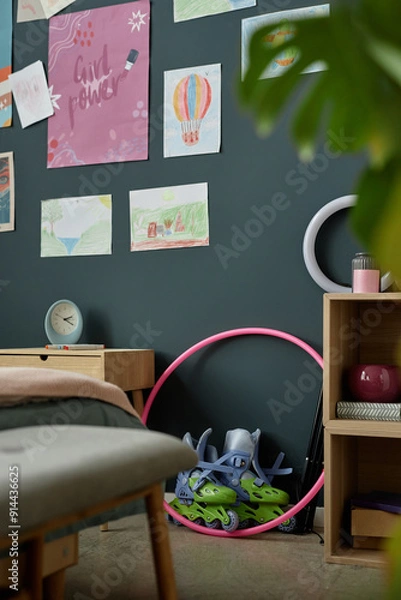 Fototapeta Vibrant children's room featuring various colorful drawings on dark wall and scattered toys creating a playful ambiance Camera is slightly tilted, focusing on one side of the playful space