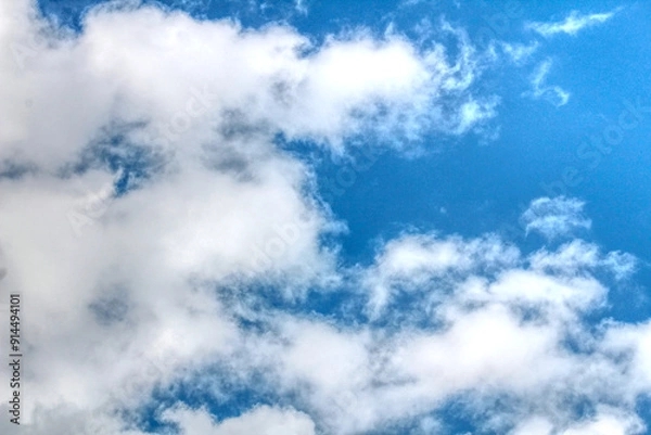 Obraz Clouds against a vivid blue sky on a summers day in June in the UK
