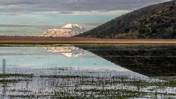 Obraz Fist light on the Limpiopungo lagoon with view and reflection of the Chimborazo volcano